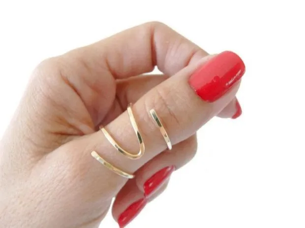 Женщины носят кольца: на большом пальце: в золотых волнах